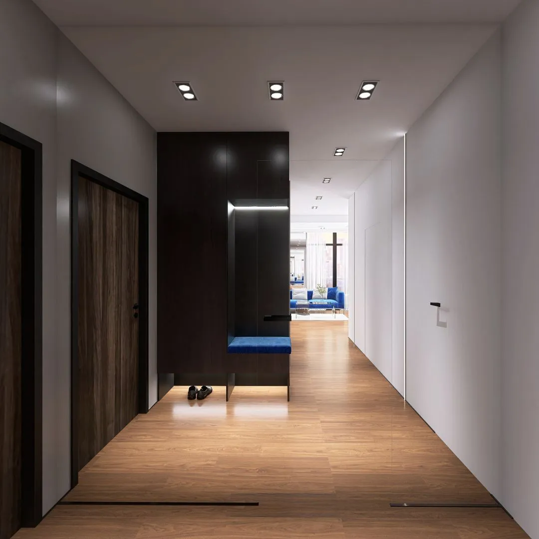 aranzacja-holu-apartament-bydgoszcz-architekt Przestronny hol z minimalistyczną garderobą, niebieskim siedziskiem i drewnianą podłogą, aranżacja wnętrz Bydgoszcz