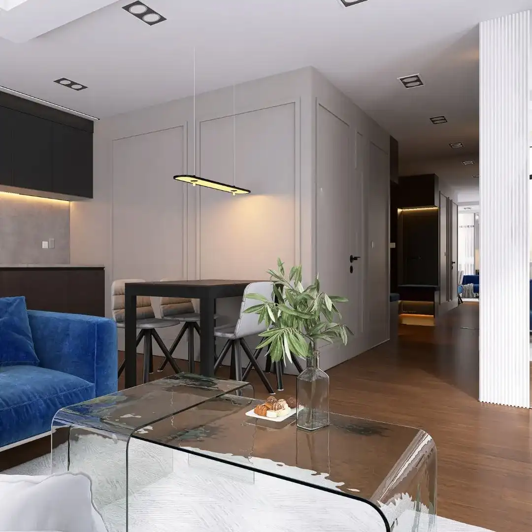 salon-z-aneksem-kuchennym-projektant-wnetrz-bydgoszcz Nowoczesny salon z aneksem kuchennym, niebieska sofa i szklany stolik, projekt wnętrz Bydgoszcz